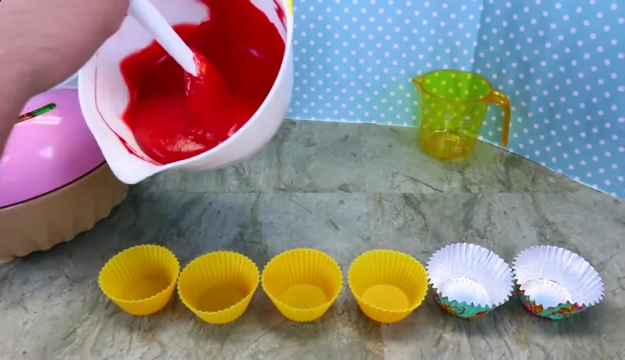 Pouring the batter into the silicone baking cups.