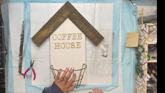 Secure the basket: Attach the wire basket to the screw eye hooks.