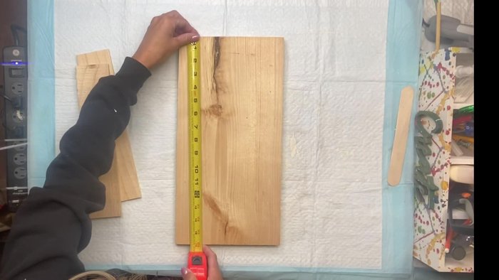 Prepare the wood: Cut and paint the main board (16x8 inches) and two smaller pieces (11.5x2.5 inches).