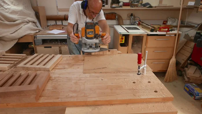 Round over edges: Use a 9mm radius round over bit on the back support piece and sides and top of the stand. Then use a 3.2 mm round-over bit on the slots to prevent breakout when rounding over the top edge.