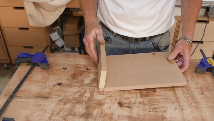 Glue and clamp: Apply glue to the support piece and clamp it to the main piece using an angled MDF jig.