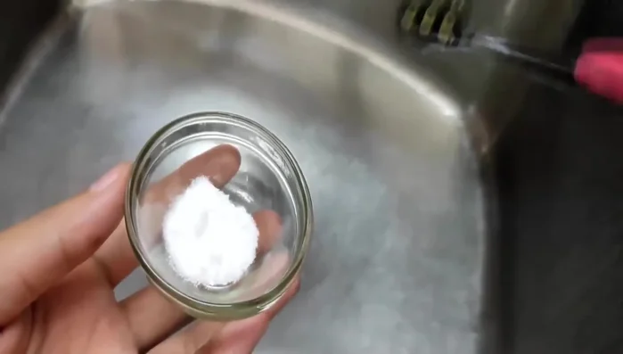 Wet your toothbrush and the mold.