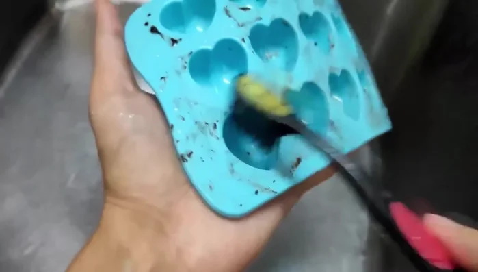 Wet your toothbrush and the mold.