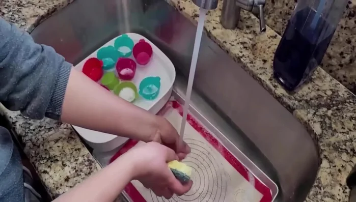 Submerge the silicone in the hot soapy water and allow it to soak for an hour.