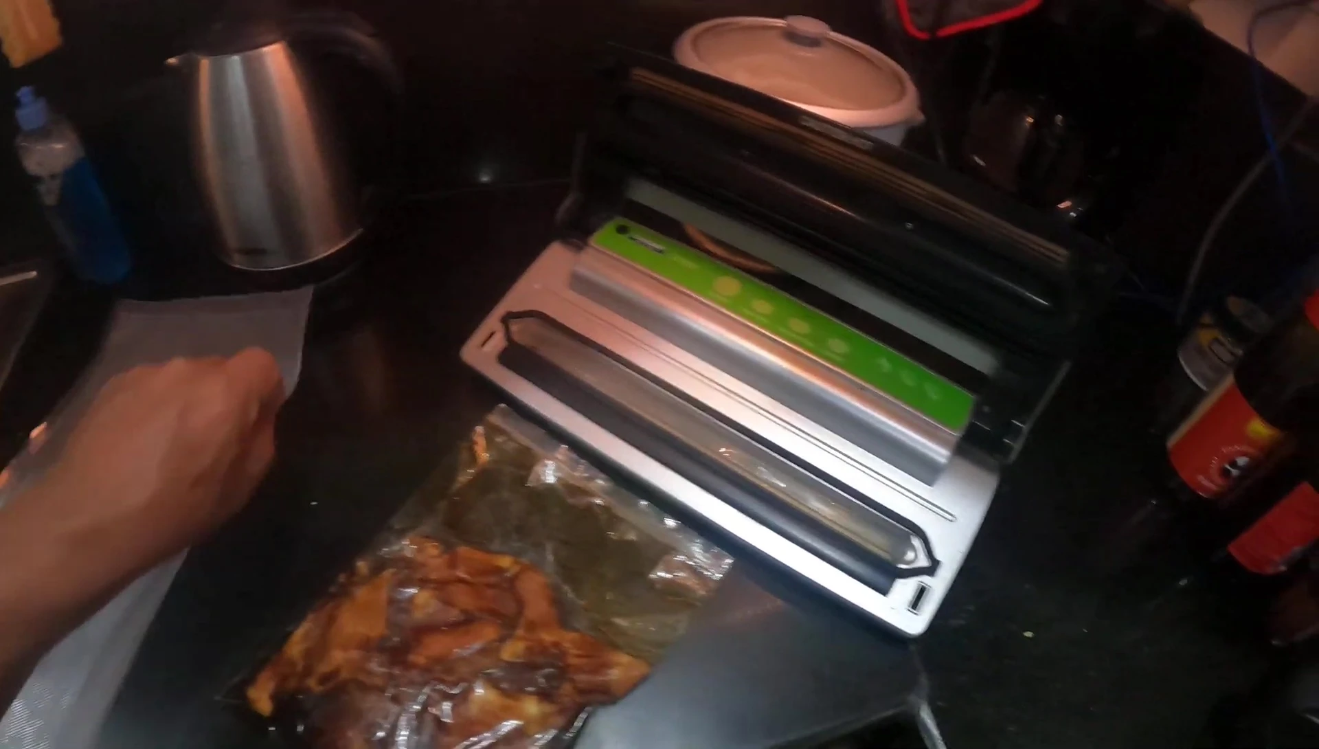 Close-up shot of the vacuum sealer machine with a bag that has liquid inside