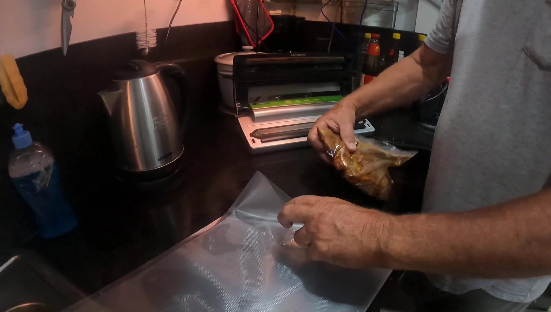 The bag is placed upside down in the vacuum sealer with the opening at the bottom.