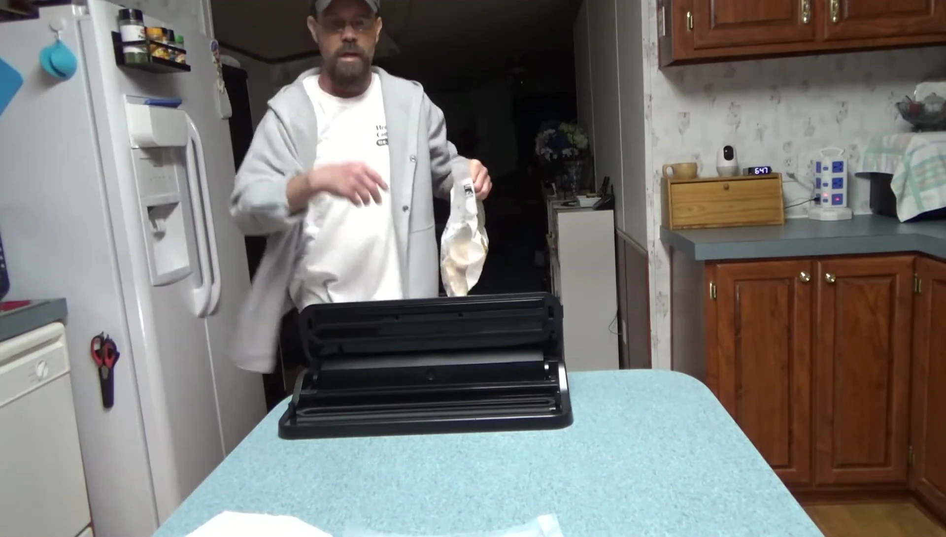 The reviewer placing pre-packaged chicken into the vacuum bag.