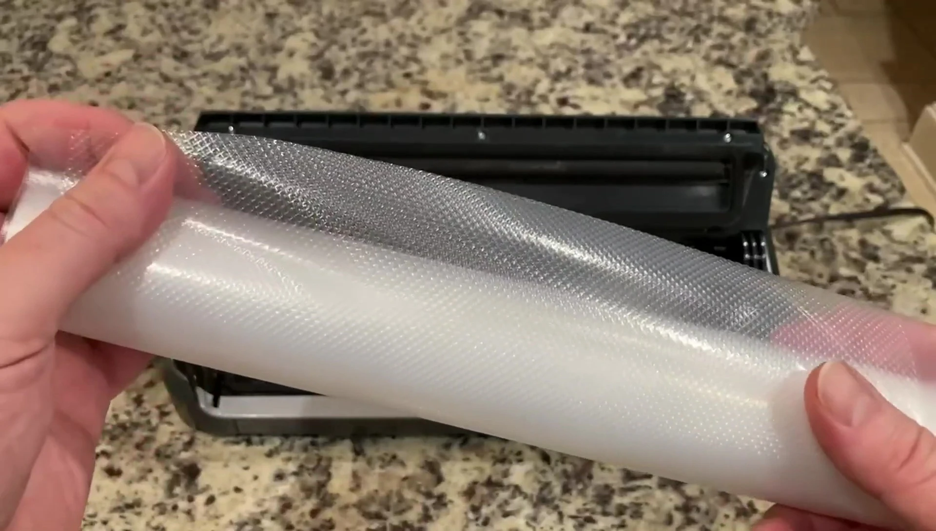 A vacuum-sealed bag of cooked brisket in the freezer