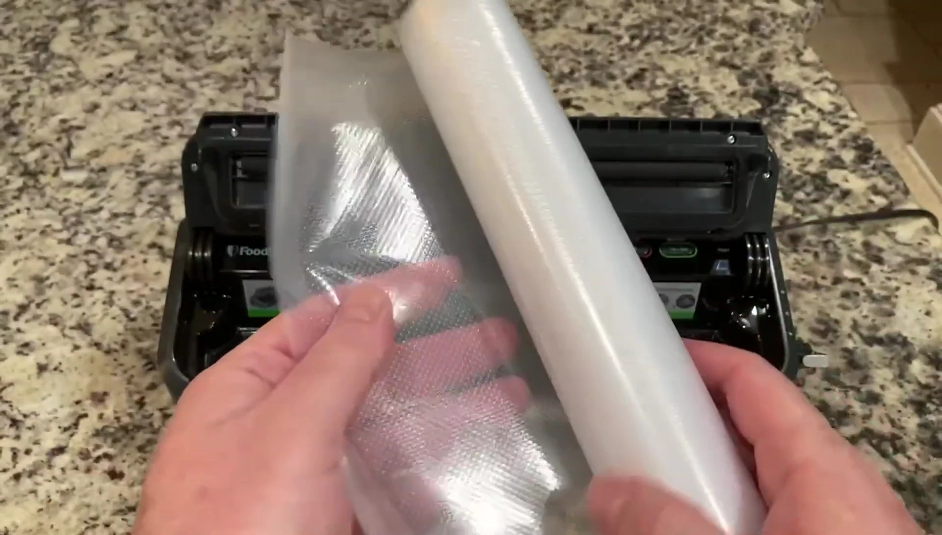 A vacuum-sealed bag in a pot of water