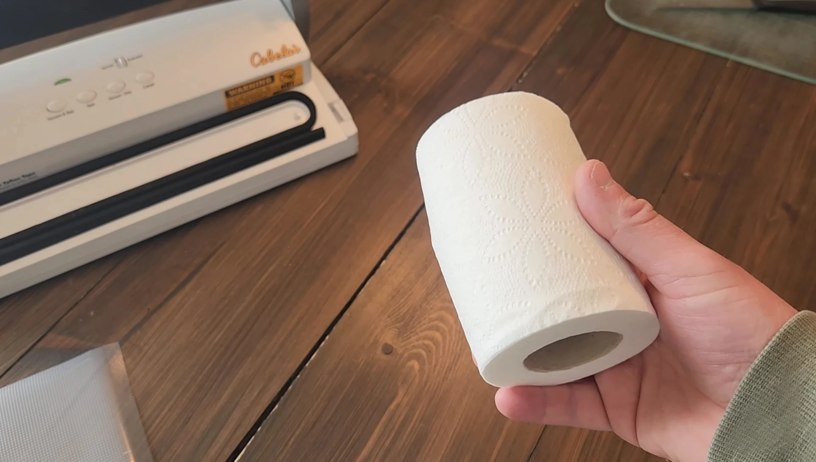 Roll of toilet paper being vacuum sealed.