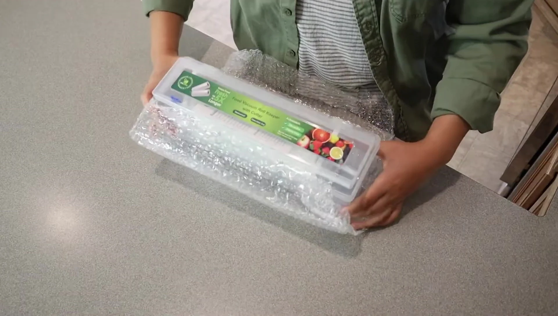 The vacuum seal roll keeper and cutter shown in its packaging.