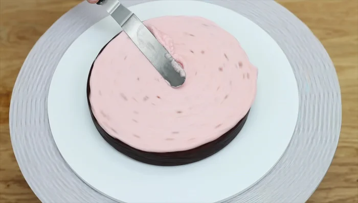 Apply the crumb coat while the cake is still frozen. The frosting will glide on smoothly.