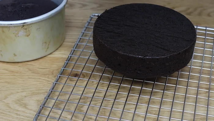 Bake and completely cool your cakes. Level, divide, and drizzle with simple syrup if desired (while still at room temperature).