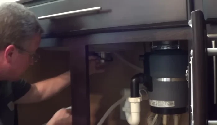 Place the rubber washer, then the cardboard gasket (friction ring) onto the nut. The gasket prevents the nut from distorting the rubber washer.