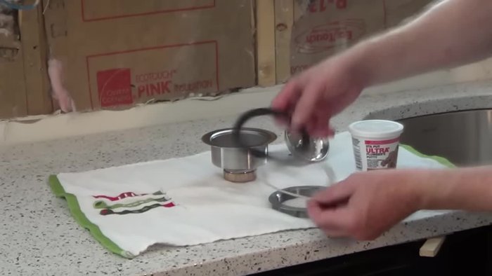 Remove the large nut from the sink basket.