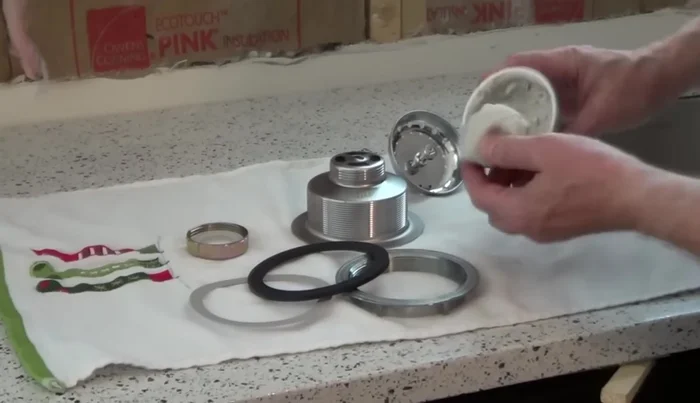 Apply a rope of non-staining plumber's putty (about the thickness of your finger) around the underside of the sink basket flange.