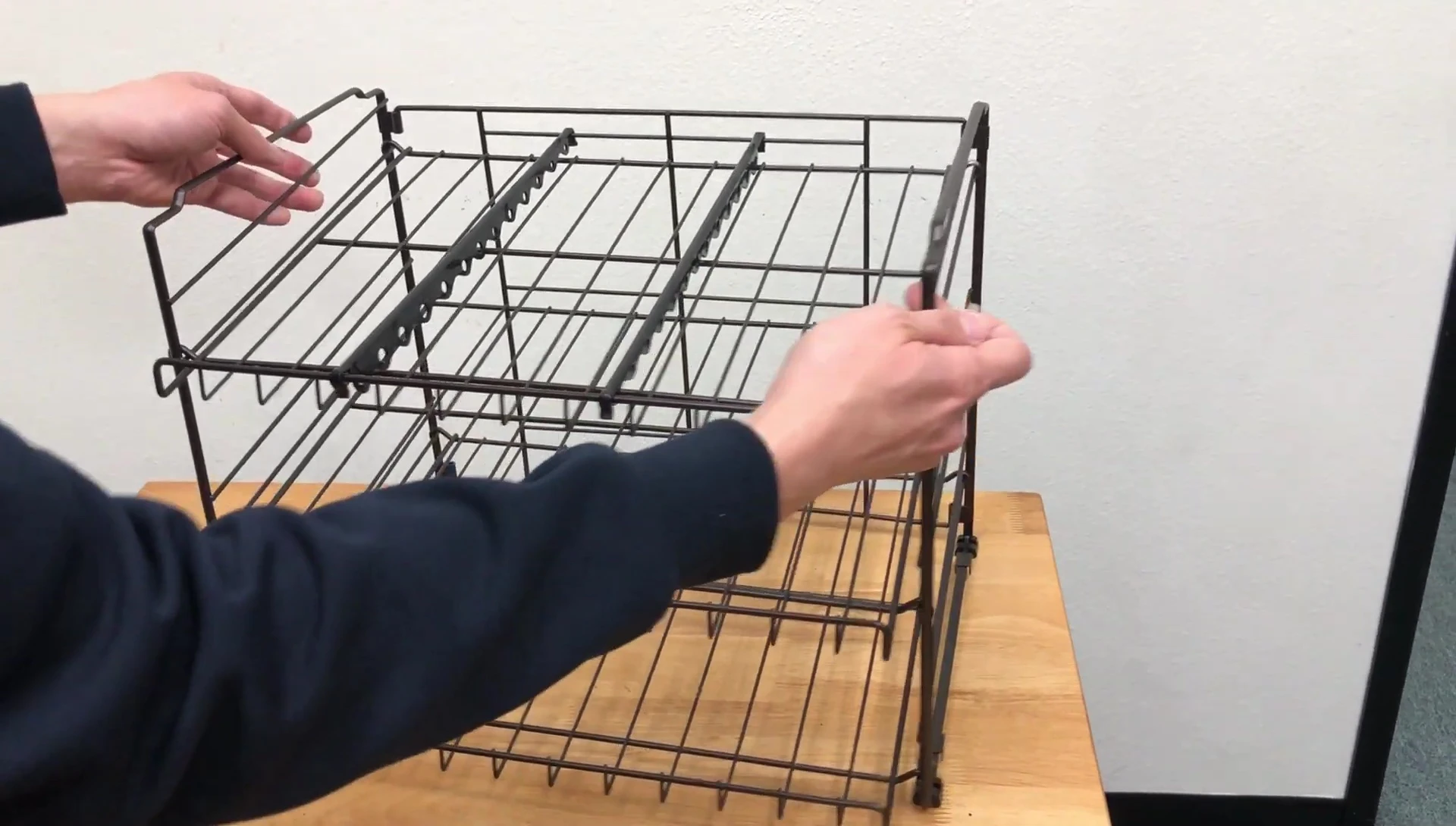 Close-up shot of attaching the plastic end caps to the rack.