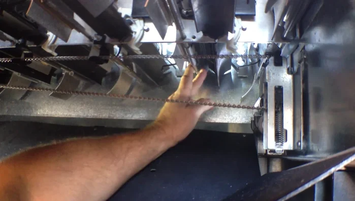 Carefully pull the rods to adjust the width to accommodate your package type. For cans, the rods go in the bottom position; for bottles, the top position. Reinsert the rods and double-check your adjustment.