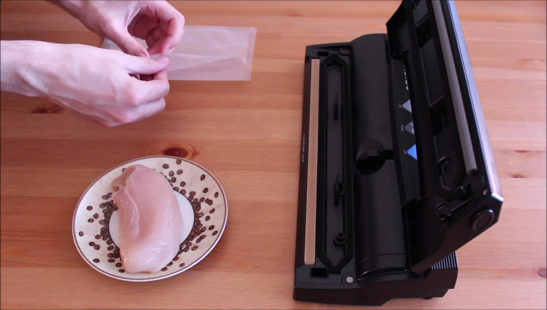 The vacuum sealer in operation, with a piece of chicken being sealed