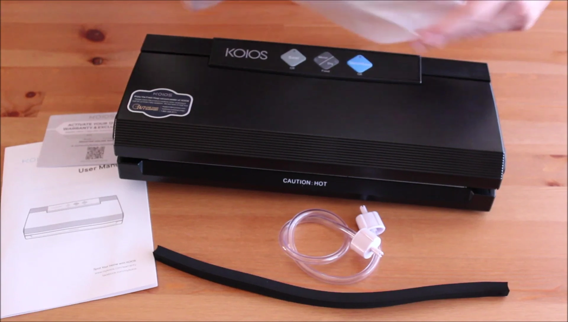 Shot of the vacuum sealer accessories laid out next to the device