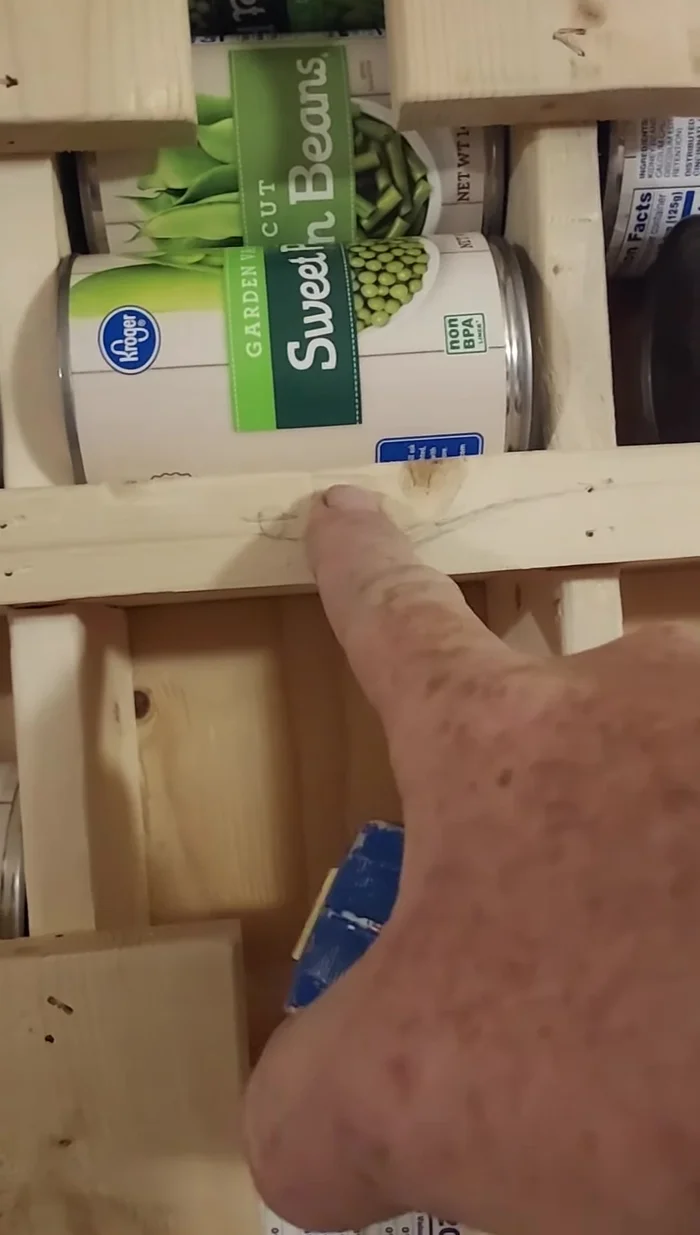 Add a backstop (optional): Place a block of 3/4 inch square wood at the back to force the last can to jut out for easy dispensing.