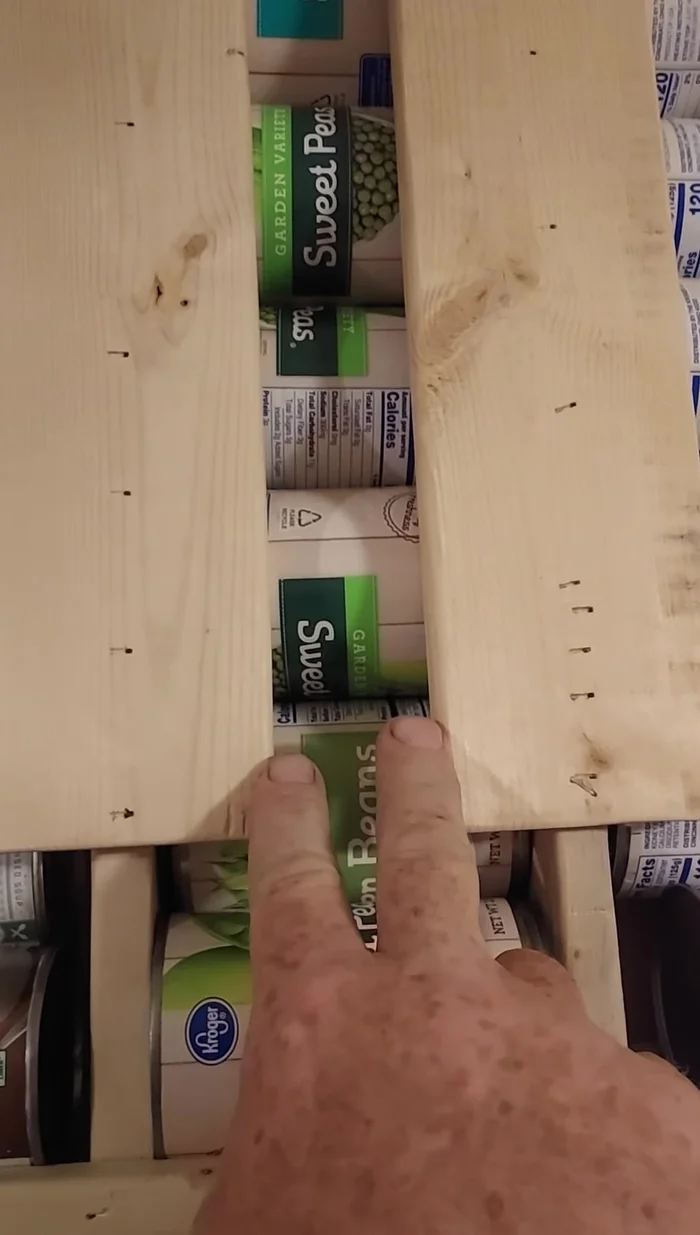 Add a backstop (optional): Place a block of 3/4 inch square wood at the back to force the last can to jut out for easy dispensing.