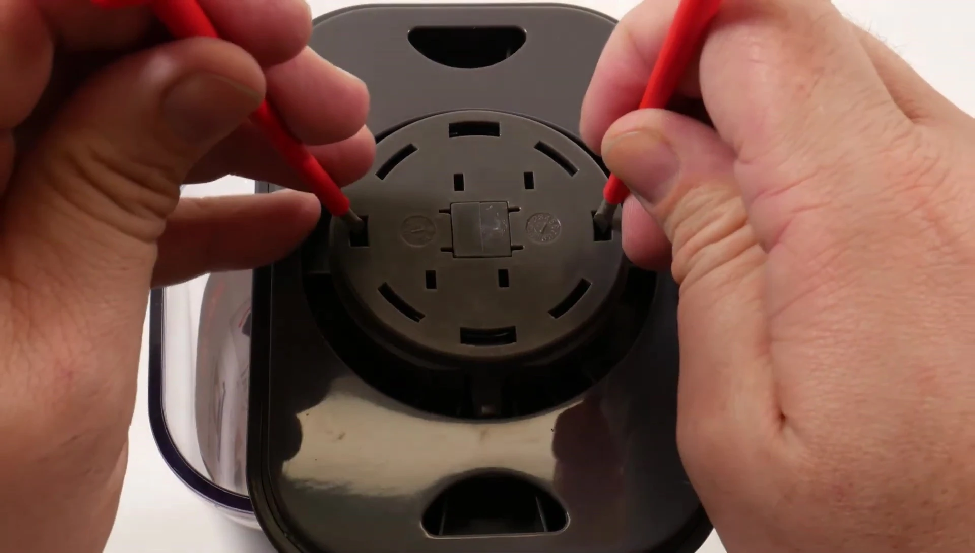 Using screwdrivers to release the depressed button