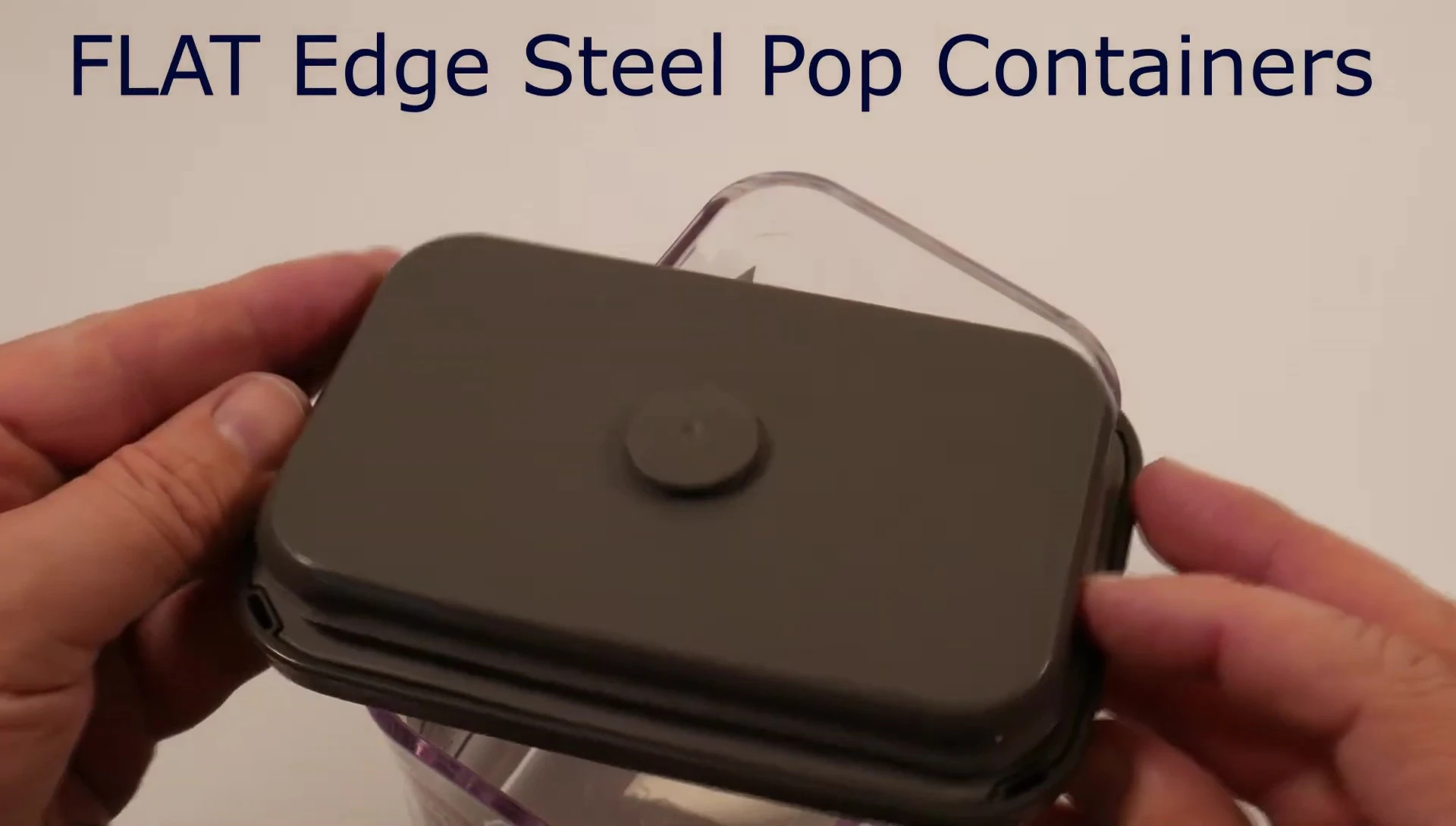 Showing the flat-edged container and its button.