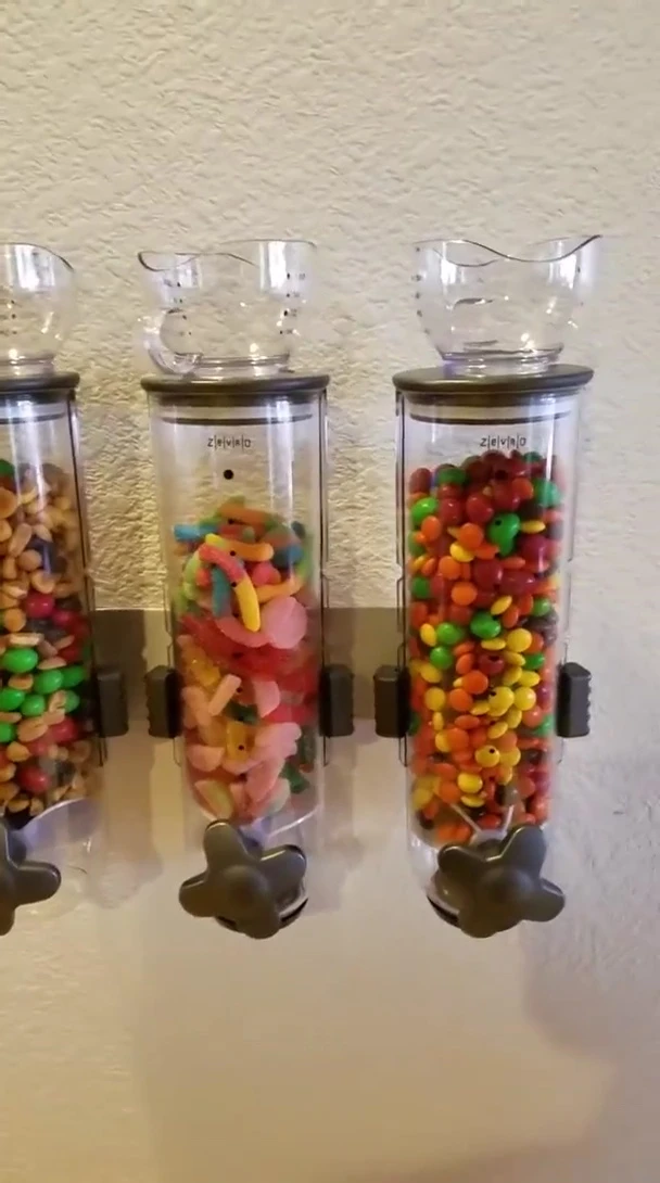 Close up shot of trail mix and candy inside the dispensers.