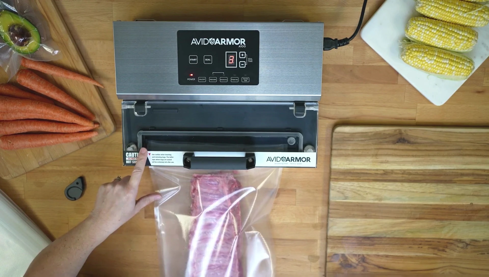 Pressing the start button to initiate the vacuum seal