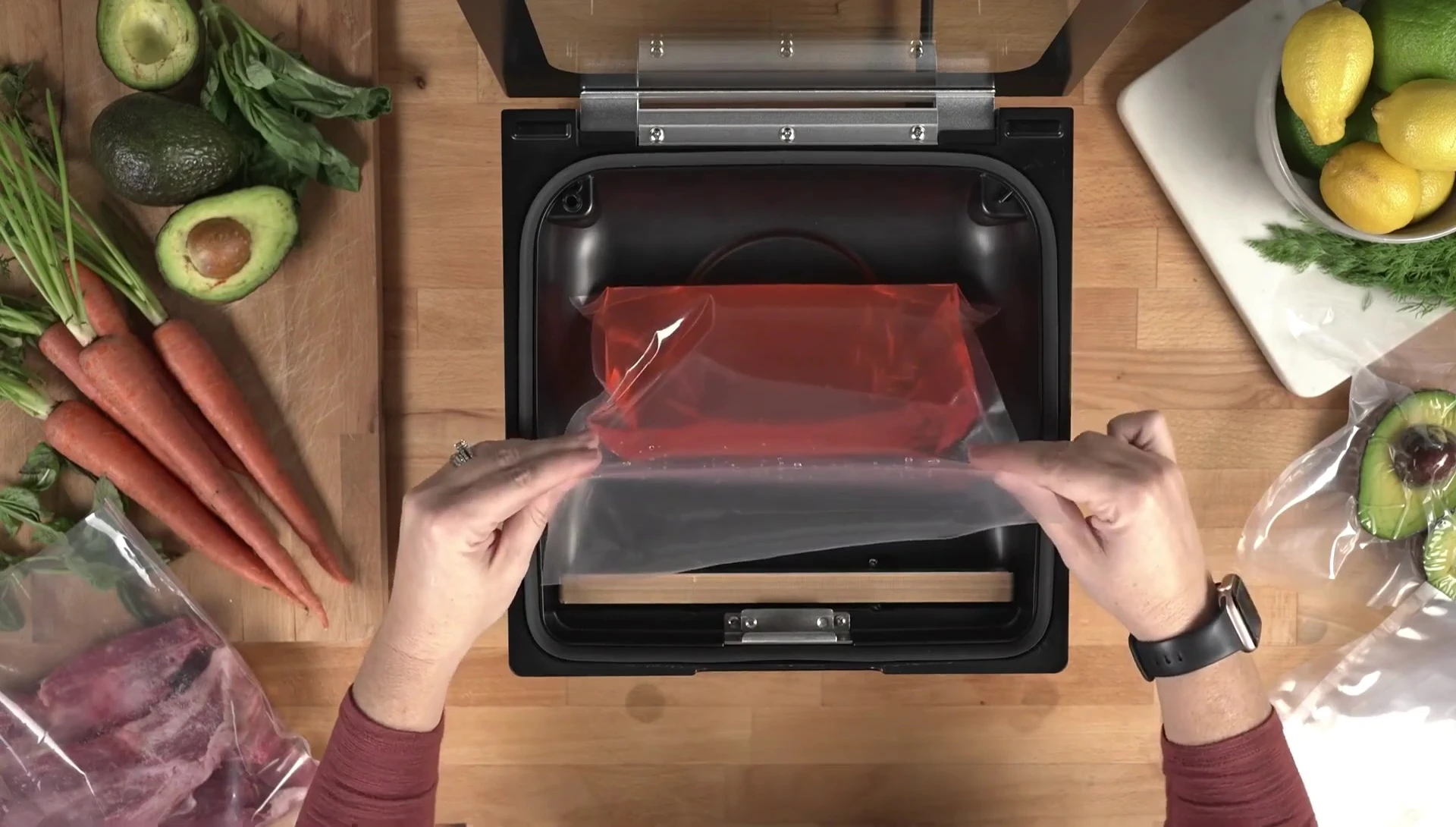 The liquid pouch being placed into the chamber of the vacuum sealer.