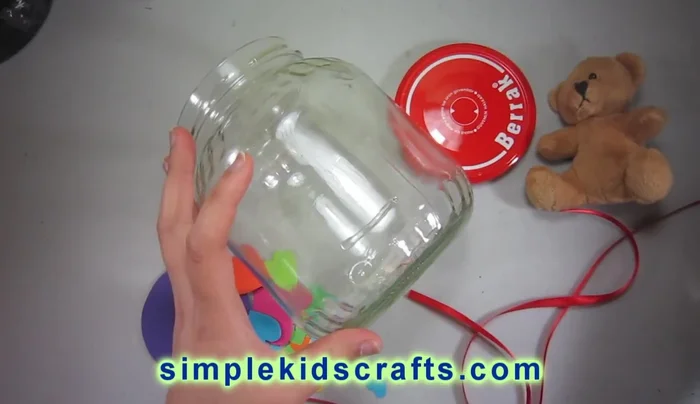 Attach the ribbon: Use glue (super glue recommended) to secure a decorative ribbon around the jar.