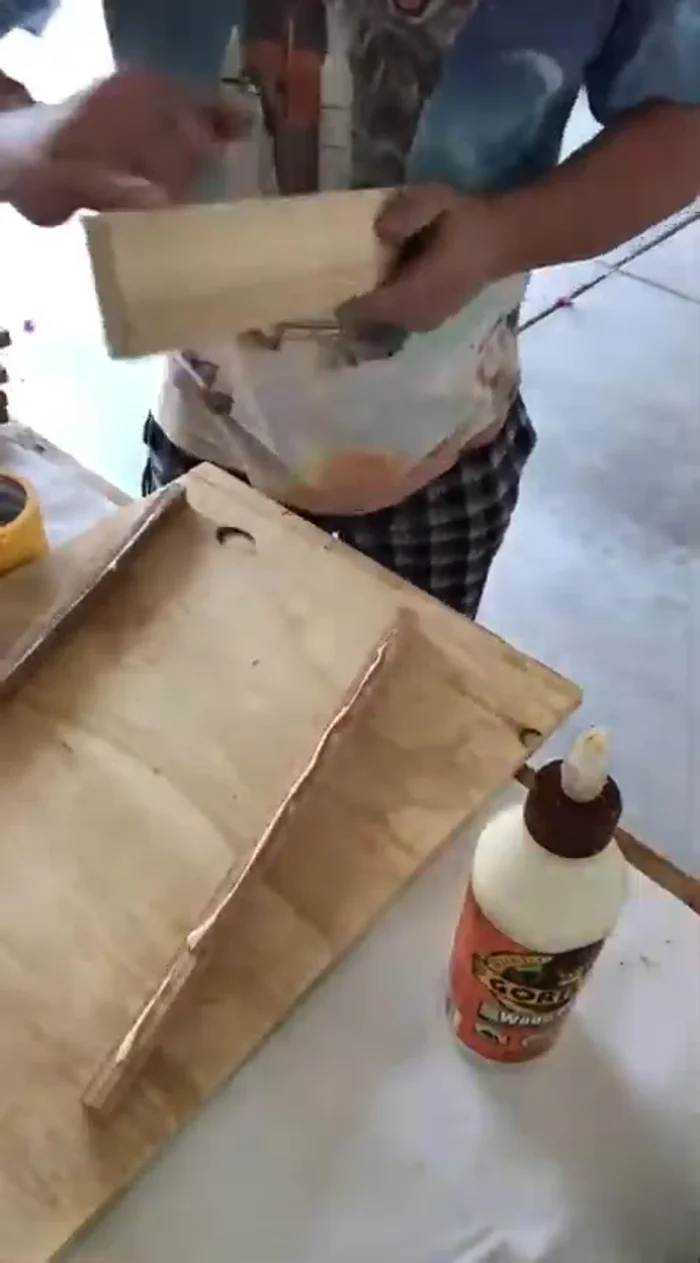 Glue the 0.5-inch strips onto the sides of the main boards, using tape to hold them in place while the glue dries.