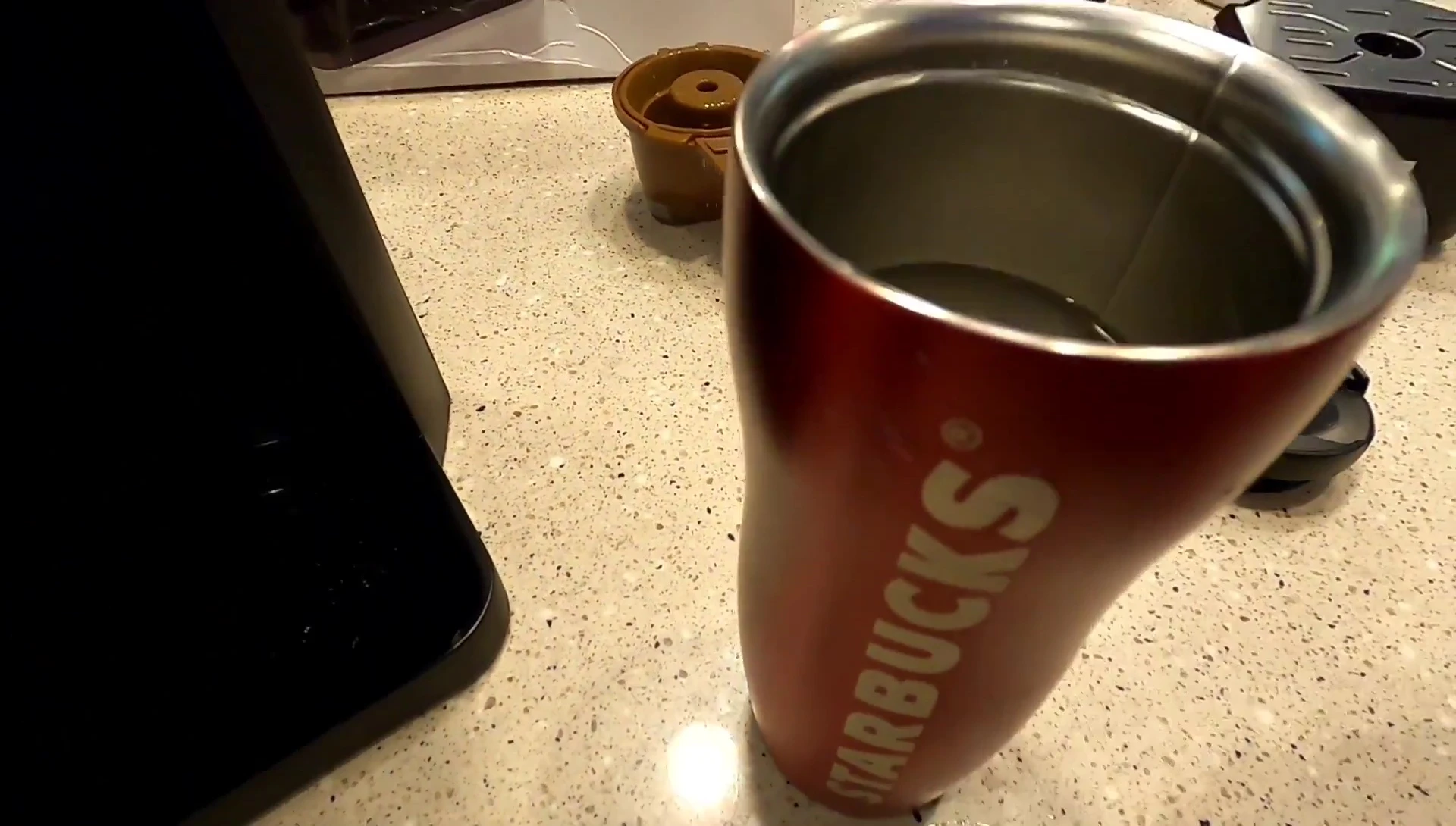Adding water to the reservoir for K-cup brewing.
