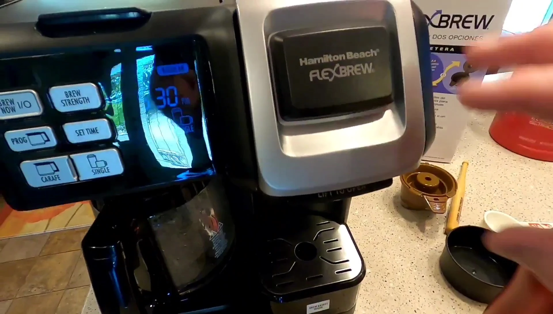 Removing the used K-cup and cleaning the drip tray.