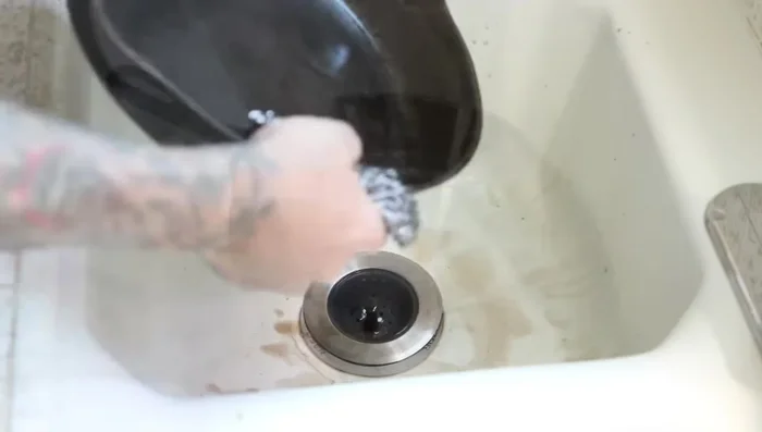 Scrub the skillet thoroughly to remove all residue. Make sure the pan is completely clean.