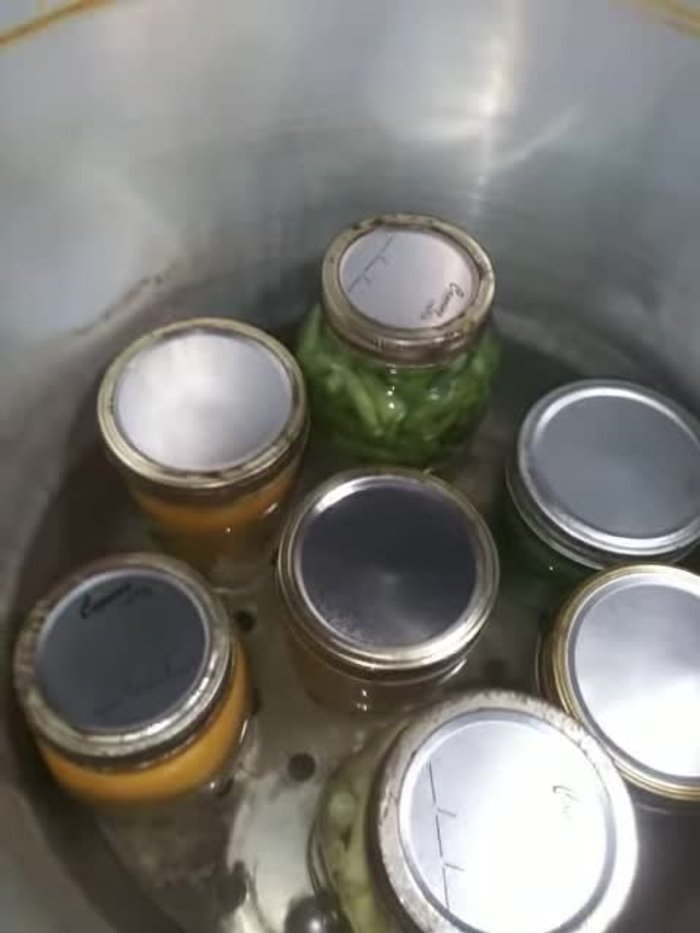 Place your first layer of jars (e.g., cheese sauce) in the pressure cooker.